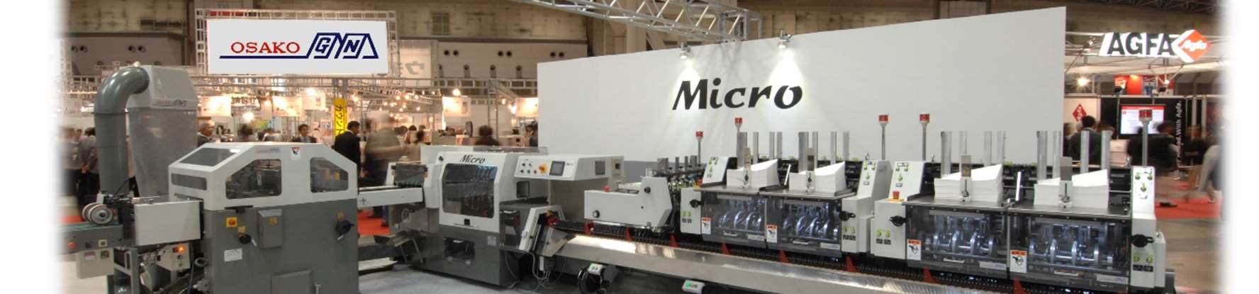 Full Micro saddle-stitcher line at exhibition (extracted from Micro catalog PDF) — feeders, ORC-315 folder feeder, stitcher, trimmer