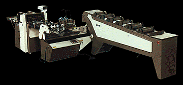 Official Rosback factory photo of the 203 Bindery System / Reliant 318 saddle-binding line (6-pocket auto-feeder + stitcher + 3-knife trimmer).