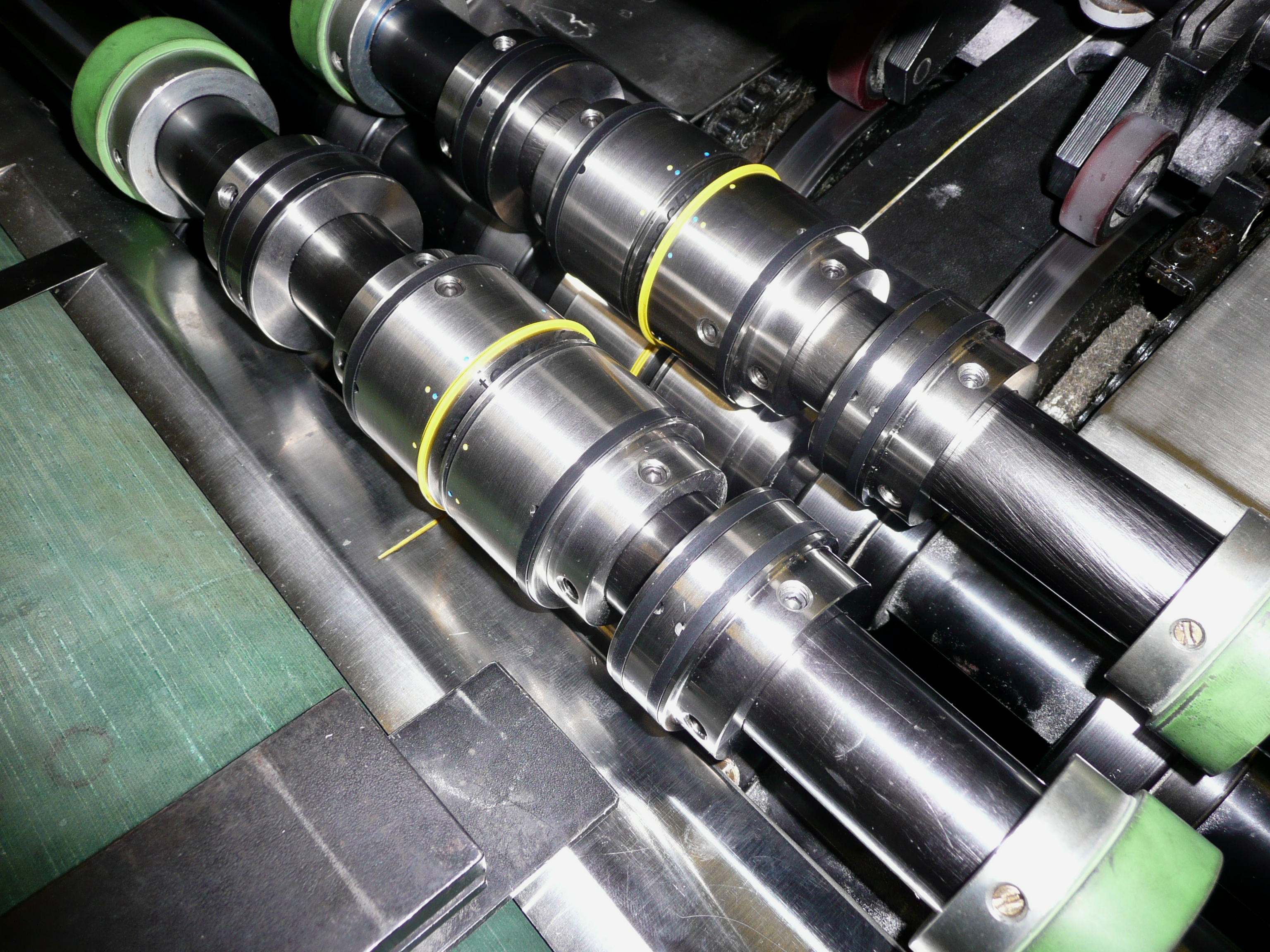 Quad-Creaser fitted on the cover scoring shafts inside a running perfect binder