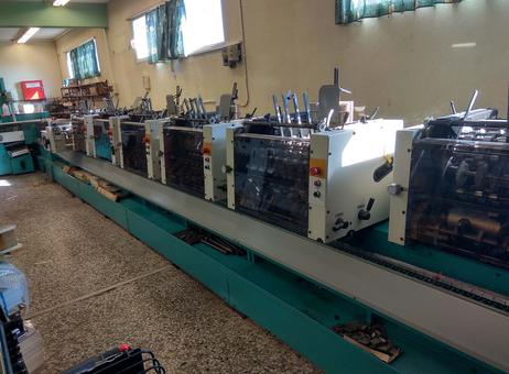 McCain-Brehmer S1000 saddle stitcher line with six feeders and cover station — dealer photo (Exapro, OEM defunct)