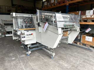 Theisen & Bonitz tb 304 QSM stitch-fold-three-knife-trim unit on castors — dealer photo (PressCity, OEM defunct)