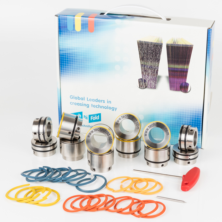 Studio: boxed quad creaser kit, branded holders, blue yellow orange spare bands, hex key