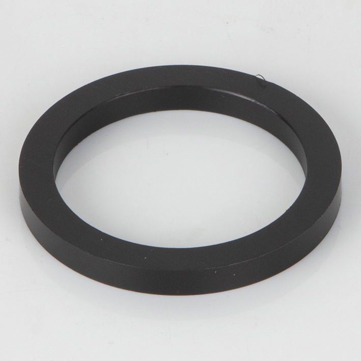 Black plastic spacer ring on white background