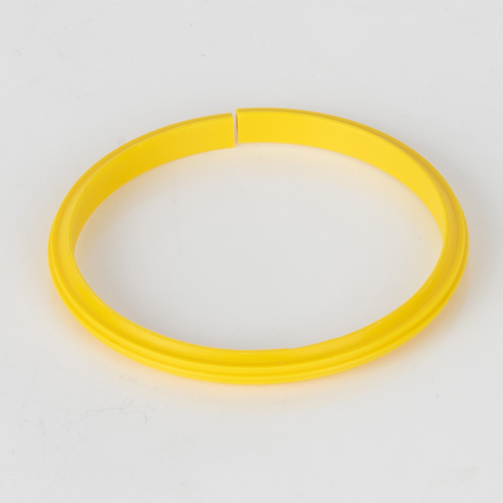 Yellow plastic quad-creaser creasing rib, full ring studio shot