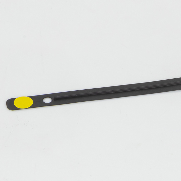 Black flat creasing matrix strip end with yellow dot and punched hole