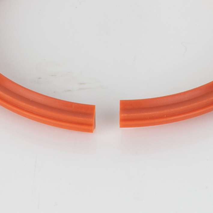 Extreme close-up of orange split gripper crease band gap ends