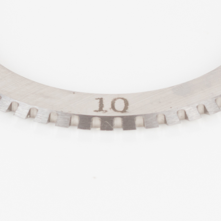 Macro close-up of 10 TPI micro-perf blade teeth, engraved 10