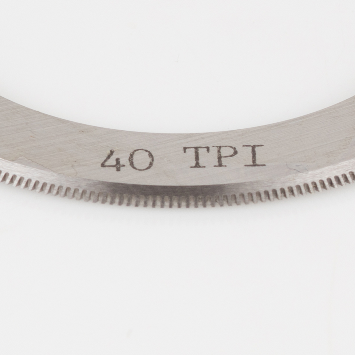 Macro close-up of 40 TPI engraving and teeth on micro-perf blade