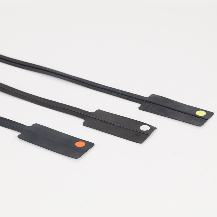 Three black creasing matrix strips with orange, white and yellow colour dots