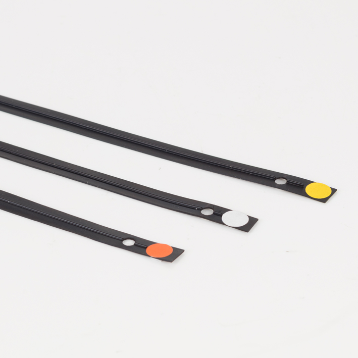 Three black creasing matrix strips with orange, white and yellow dot markers