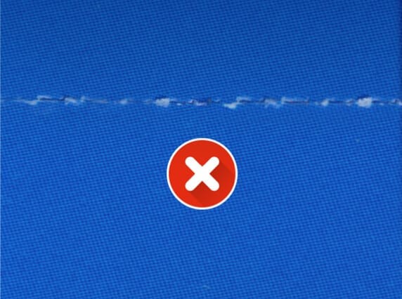Ragged burst perforation line from a standard folder perf wheel on blue stock