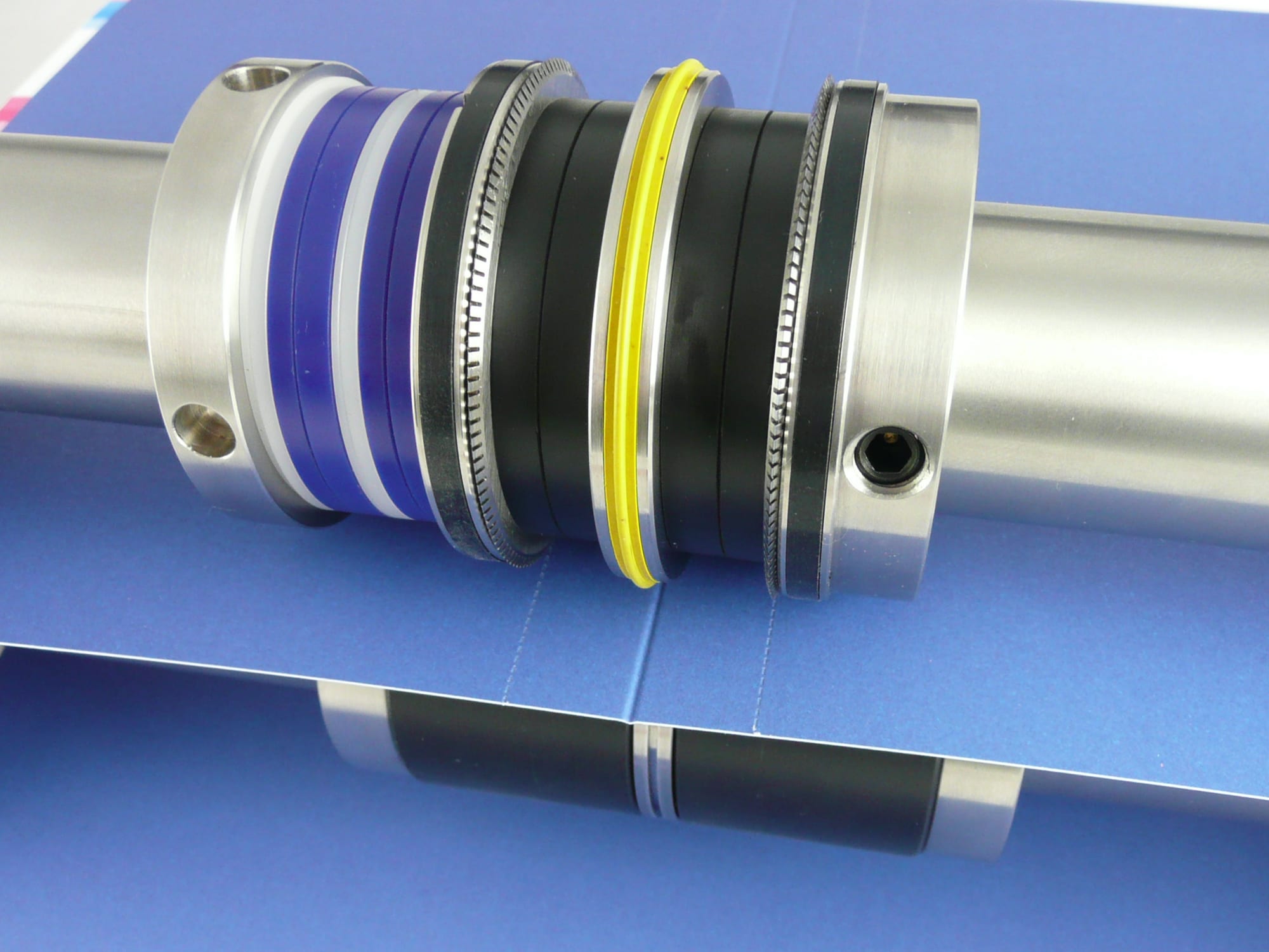 CP Applicator creasing and double-perforating a blue sheet in one pass on the folder shafts