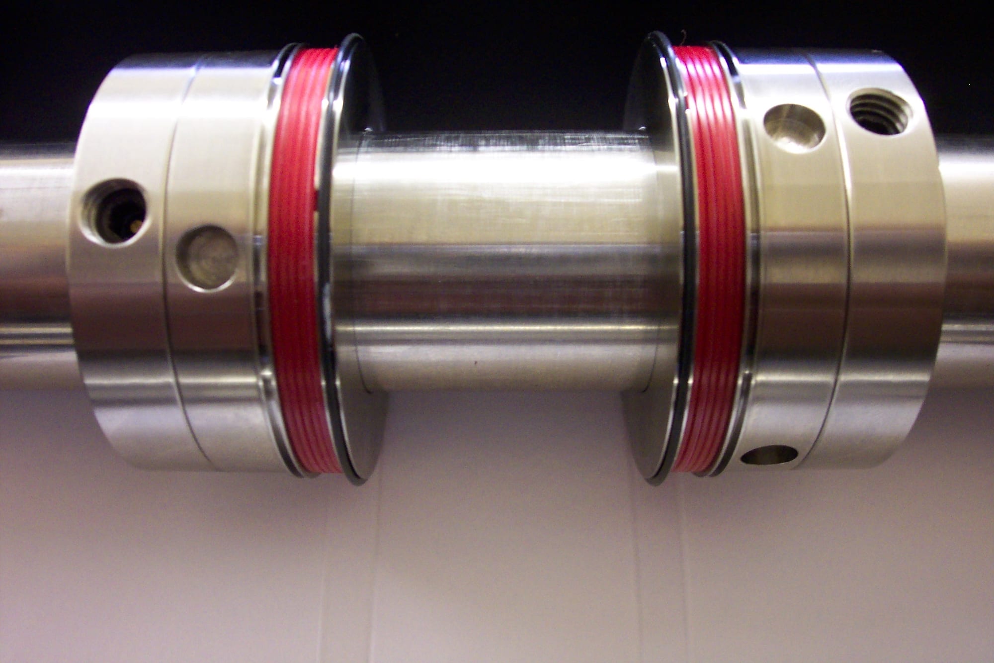 Spine-Hinge Creaser pair with red creasing bands, creased sheet below