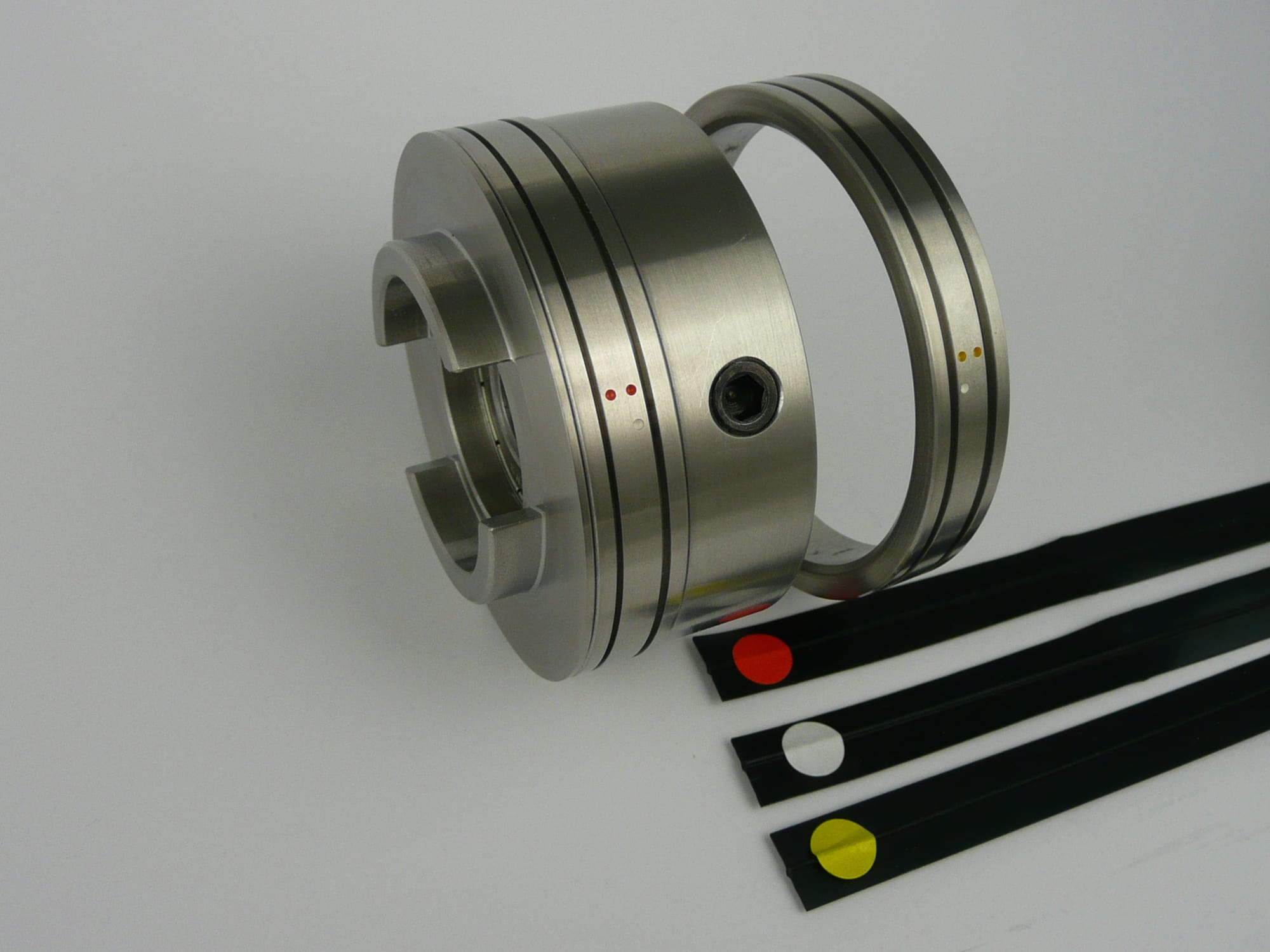 Studio shot of stainless Spine-Creaser hub and ring with three colour-dot creasing rib strips